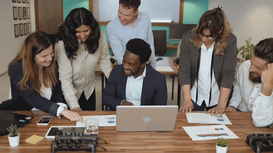 A GIF of a group of people collaborating in the table